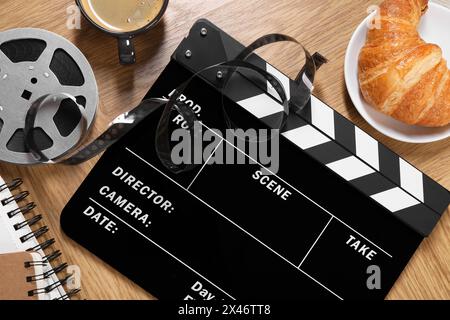 Flat lay composition with movie clapper on wooden table Stock Photo