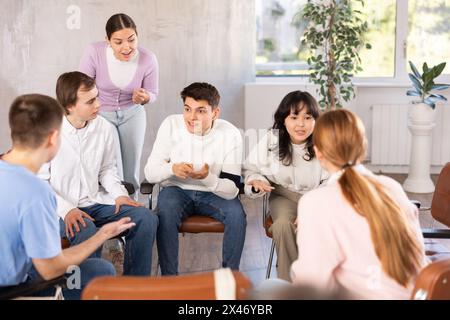 Group of students engaged in discussion in classroom Stock Photo