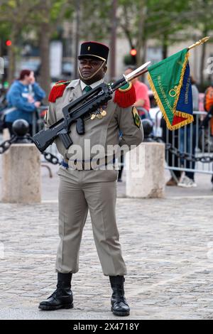 Pairs, France. 29th Apr, 2024. A Sargent stands at ease during a friendly revival ceremony for the alumni of the Paris Foreign Legion and Foreign Legion units at the Arc de Triomphe. Against the backdrop of the Arc de Triomphe, Paris, alumni and units of the Paris Foreign Legion held a ceremonial gathering . Adhering to tradition, the event honors the Legion's legacy of service and sacrifice. Veterans and active members participate in formalities, including flag presentations and medal ceremonies. The event underscores the unit's historical significance within the French Army and commemorates Stock Photo