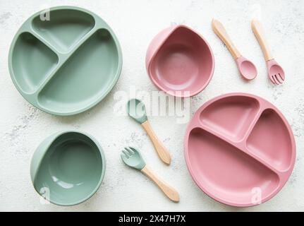 Collection of reusable colorful plastic dishes and bowls for baby food Stock Photo