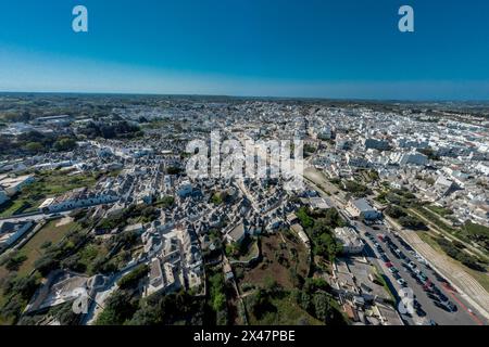 Aerial drone view of Beautiful stone Trulli houses with narrow streets in village of Alberobello. Picturesque village on a hill in Apulia, southern it Stock Photo