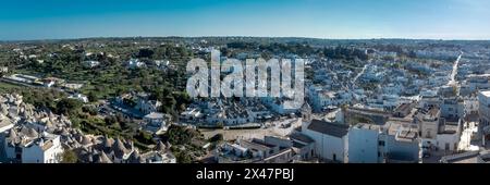 Aerial drone view of Beautiful stone Trulli houses with narrow streets in village of Alberobello. Picturesque village on a hill in Apulia, southern it Stock Photo