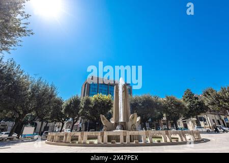 Water fountain in the centre of Brindisi city, part of Apulia in southern italy. Warm spring day with sun Stock Photo