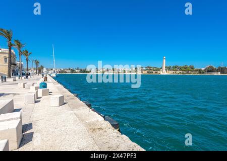 Lungomare in Brindisi, a pedestrian walkway next to the beach and surrounding old town. Row of palms are visible on a warm spring day Stock Photo