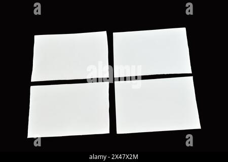 On a black background there are four clean white paper sheets with straight edges. Stock Photo