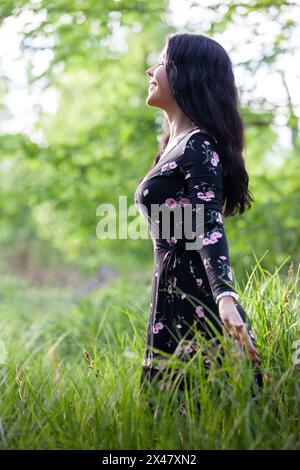 Young dreamy woman enjoying beautiful moments in nature. Stock Photo