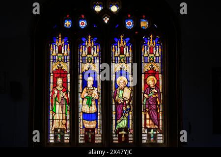 Vibrant stained glass window inside St Michael the Archangel parish church, Lyme Regis, Dorset, England, UK Stock Photo