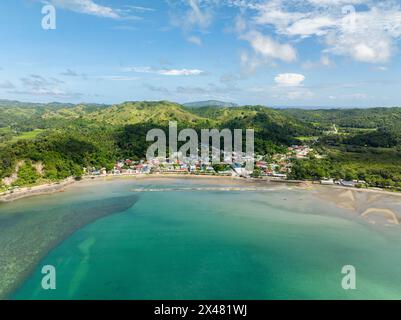 Residential aera and buildings in Santa Fe. Turquoise sea water at shoreline. Tablas, Romblon. Philippines. Stock Photo