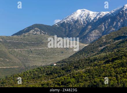 Snow capped peak of Mount Cika and mountain road over Llogara Pass, Palase, near Dhermi, Albania Stock Photo