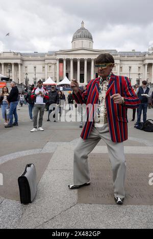 Man dressed in 1960's attire attends The Feast of St. George Festival in Trafalgar Square, April 23rd 2024 Stock Photo