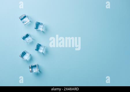 top view of ice cubes of different sizes on blue background Stock Photo