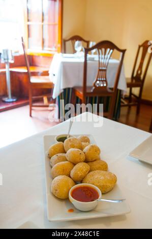 Ration of papas arrugadas with two mojo sauces in a Canarian restaurant. Madrid, Spain. Stock Photo