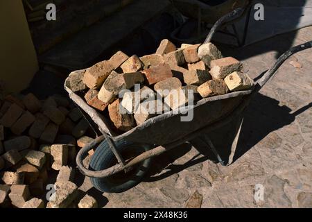 a wheelbarrow loaded with red bricks in Novo Hopovo monastery, Fruska Gora in northern Serbia Stock Photo