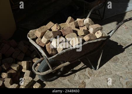 a wheelbarrow loaded with red bricks in Novo Hopovo monastery, Fruska Gora in northern Serbia Stock Photo