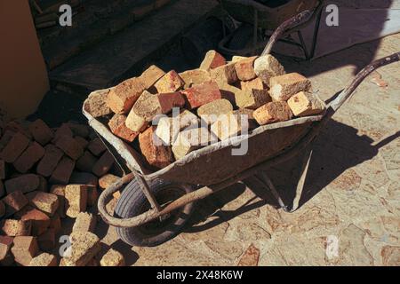 a wheelbarrow loaded with red bricks in Novo Hopovo monastery, Fruska Gora in northern Serbia Stock Photo