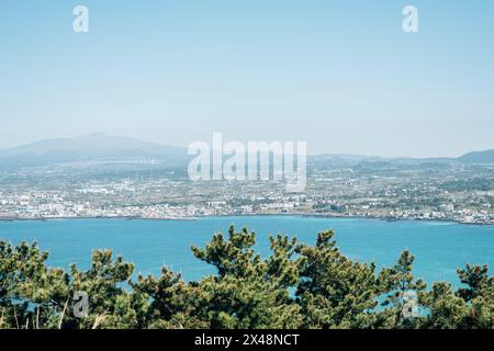 Jeju Oreum and seaside city view from Biyangdo Island Biyangbong peak in Jeju island, Korea Stock Photo