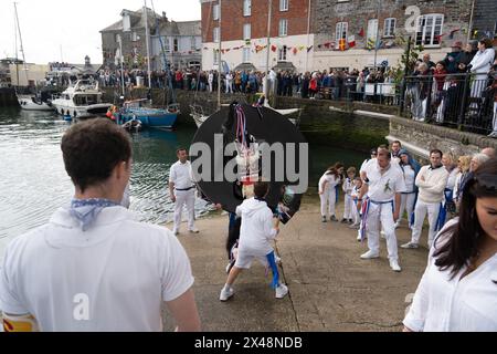 Padstow, Cornwall, UK. 1st May 2024. May Day celebrations. The streets of Padstow were packed for the traditional Obby Oss procession through the town. Credit Simon Maycock / Alamy Live News. Stock Photo