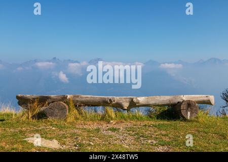 an old wooden bench on the top of the mountain Stock Photo