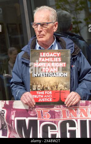 Belfast, United Kingdom 1/05/2024 Sinn Féin MLA Gerry Kelly alongside victims campaigners at Legacy Act protest. Families of those killed during the troubles hold a protest outside the Northern Ireland Office building Erskine House. The protest was organised by the time for truth and justice group. Belfast Northern Ireland Credit: HeadlineX/Alamy Live News Stock Photo