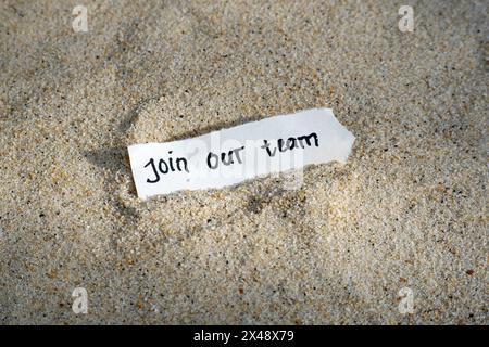 Come and join our team handwritten text on torn paper note Stock Photo
