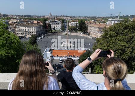 Rome, Italy. 30th Apr, 2024. Tourists observe city of Rome from Pincio Terrace with the new tennis court in Piazza del Popolo (Credit Image: © Matteo Nardone/Pacific Press via ZUMA Press Wire) EDITORIAL USAGE ONLY! Not for Commercial USAGE! Stock Photo