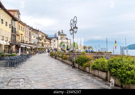 Cannobio, Piedmont, Italy - April 26, 2024: Lakefront of Cannobio with outdoor bars and restaurants, the popular holiday resort on the shore of Lake M Stock Photo