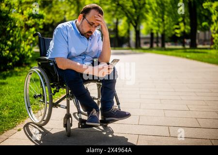 Portrait of man in wheelchair. He is worried and depressed. Stock Photo