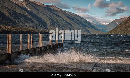 Crashing Waves Against The Docking Deck Of Lake Rotoiti At Nelson Lakes National Park, New Zealand Stock Photo