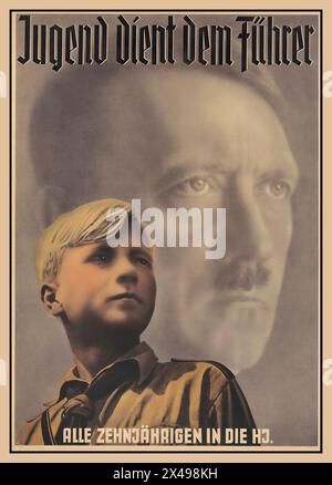 WW2 Nazi Propaganda 'Jugend Dient Dem Fuhrer'  'Youth Serves The Leader.' Hitler youth boy in uniform in front of a background image of Adolf Hitler , leader of The Nazi Party and of all Germany. Captioned at bottom All Ten Year olds join the Hitler Jugend. Propaganda Recruitment Poster 1940 Nazi Germany Stock Photo