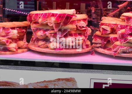 Skewers of octopus, sea bream, shrimp and sardines, grilled over a wood fire in a boat on the sand of the beach. Typical dish from Malaga, Andalusia, Stock Photo