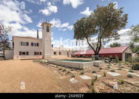 a beautiful recreational pool at the foot of a large garden with a large rural country house and wonderful oaks providing shade Stock Photo