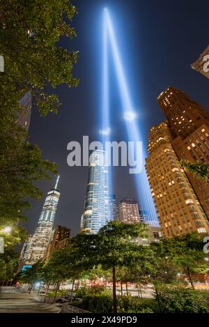 New York City commemoration of September 11. Tribute in Light. Two vertical columns of light rising between the skyscrapers of Lower Manhattan Stock Photo