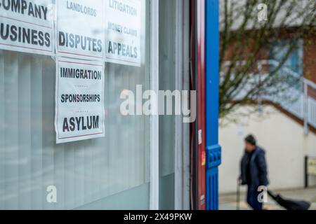 LONDON- APRIL 4th, 2024: High street solicitor on Willesden Lane in NW London advertising Immigration Disputes, Sponsorship and Asylum services Stock Photo