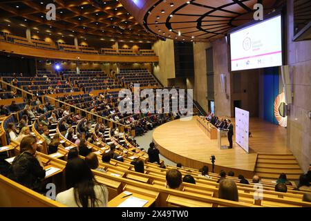 Cracow, Malopolska, Poland - 03.09.2024: Young people writing an exam in a large university auditorium. Stock Photo