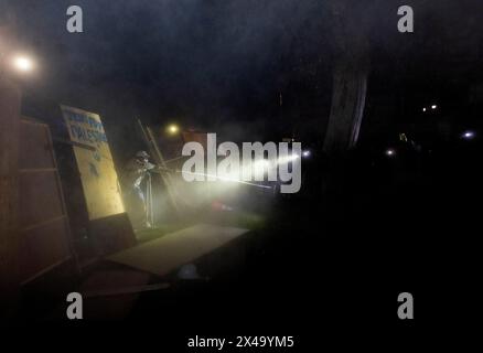 May 1, 2024, Los Angeles, California, USA: A Pro-Palestinian protester (left) brandishes a stick from their encampment, in a clash with Pro-Israel protesters (at right)who have set up an encampment near Royce Hall at UCLA in Los Angeles, Calif. The riot went on for hours in the night on April 30 lasting until the morning hours of May 1, until a couple hundred law enforcement officers arrived including university police, California Highway Patrol, LAPD and Beverly Hills police. The protesters brandished sticks and other items like umbrellas, fought, pulled down barriers, threw fireworks, spraye Stock Photo