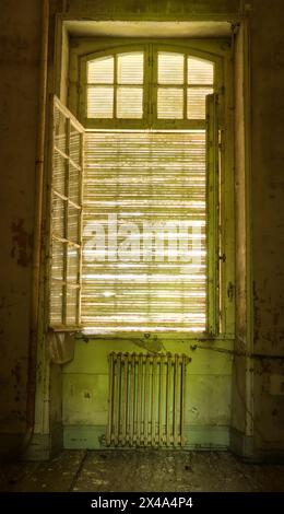 old and aged window with a rusty radiator Stock Photo