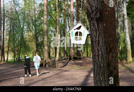 Small house with window on tree in the park. This is the feeder for squirrels and birds Stock Photo