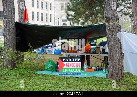 Ottawa, Canada - May 1, 2024: A pro-Palestinian protest has evolved from a sit-in to an encampment as several tents have been erected on the lawn of Tabaret Hall. This is despite the fact that the University declared that no encampments would be tolerated the day before. The group is demanding that the University disclose and divest any Investments it has with companies and organizations with ties to Israel. Similar protests have been taking places in other universities of the world. Stock Photo