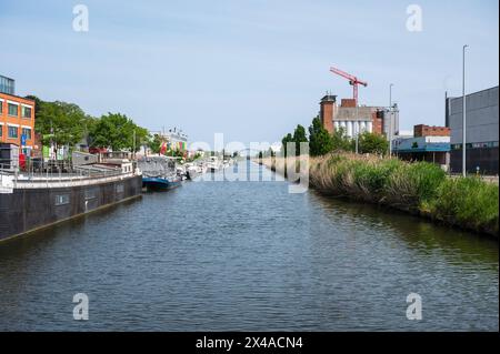 Leuven, Flemish Brabant, Belgium - May 29, 2023 - The Leuven Mechelen canal with green banks and a boat Stock Photo