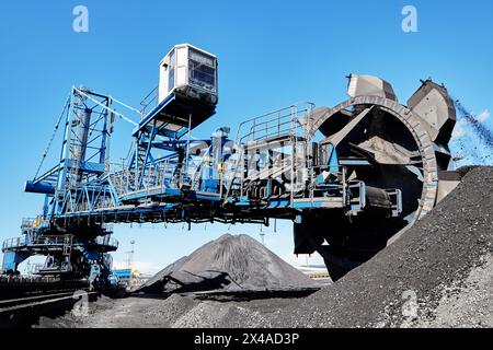 Bucket wheel stacker reclaimer in maritime bulk terminal of coal harbor. Stock Photo