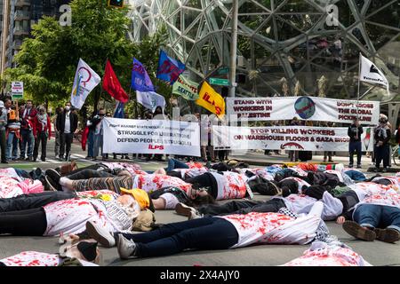 Seattle, USA. 1st May 2024. Protestors in the Seattle May Day March gathered at 10:00am in the Westlake Shopping district. The group marched through the city stopping at the Amazon Spheres Campus for a mass die-in for Palestine. The group then continued on to the Hyatt Hotel to denounce the meeting of Gas and Oil pipeline officials. Credit: James Anderson/Alamy Live News Stock Photo