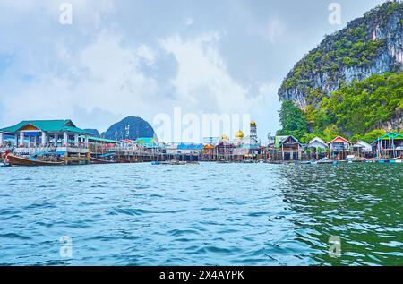 The colorful stilt houses and boats of Muslim village of Ko Panyi (Koh Panyee), located in Phang Nga province, Thailand Stock Photo