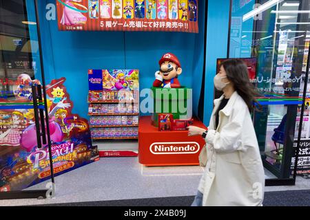 Woman walks past a Nintendo display with Super Mario and Princess Peach in a shopping mall in Osaka on April 16, 2024. Credit: Stanislav Kogiku/AFLO/Alamy Live News Stock Photo