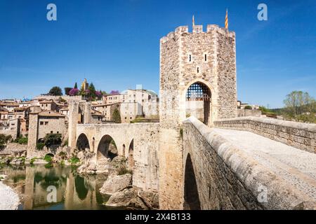 The medieval bridge of Besalú that crosses a river Fluvia allows the entrance to the village. The bridge is made of stone and has a tower on top. Embl Stock Photo