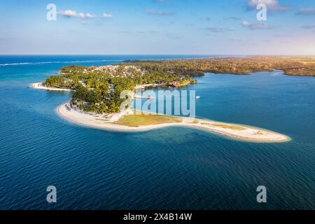 Drone overhead view of the beach of Constance Belle Mare Plage in Mauritius, with palm trees, umbrellas and a beautiful turquoise sea with transparent Stock Photo