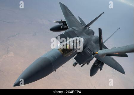 A U.S. Air Force F-15E Strike Eagle from Seymour-Johnson Air Force BaseÕs 335th Fighter Squadron receives fuel from a KC-135 Stratotanker from the Ten Stock Photo