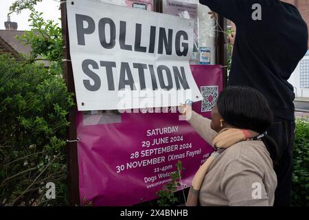 Polling station staff attach posters outside St Barnabas Parish Hall in Dulwich Village, on the day that Londoners vote for their mayor and London Assembly members, on 2nd May 2024, in London, England. Stock Photo