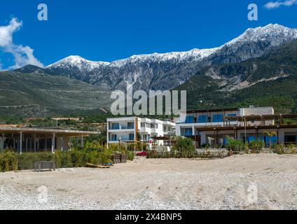 Tourist development construction building work view from Drymades beach to Mount Cika snow capped mountain range, Dhermi, Albanian Riviera, Albania Stock Photo