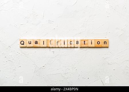 Qualification Text qualification word written on wood block. qualification text on table ...