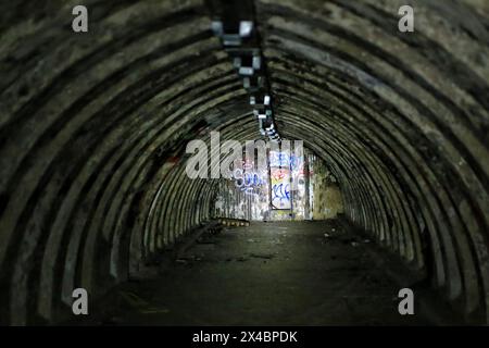 Abandoned tunnel bunker, partially illuminated by a flashlight. Stock Photo